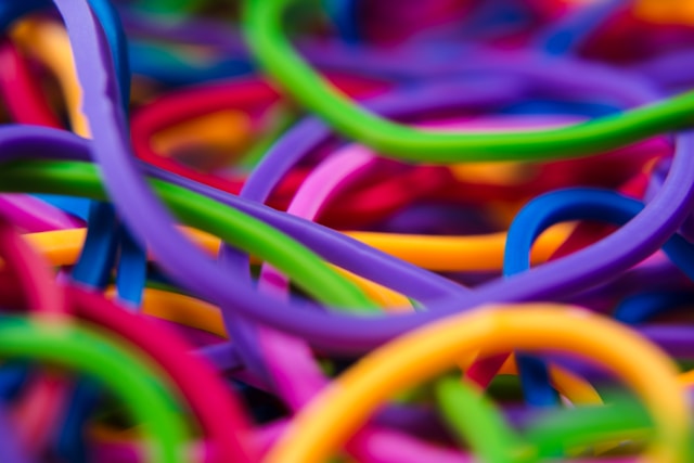 Close up macro shot of colourful elastic bands. Be flexible to make steady progress.