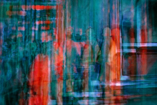 Abstract artwork. Red and aqua streaks with blurry silhouettes of people. Unconscious restrictions.