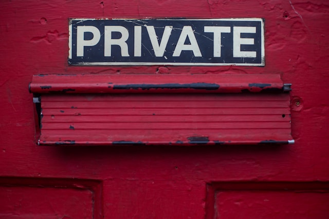 Close up of red door with "PRIVATE" printed on it in bold.