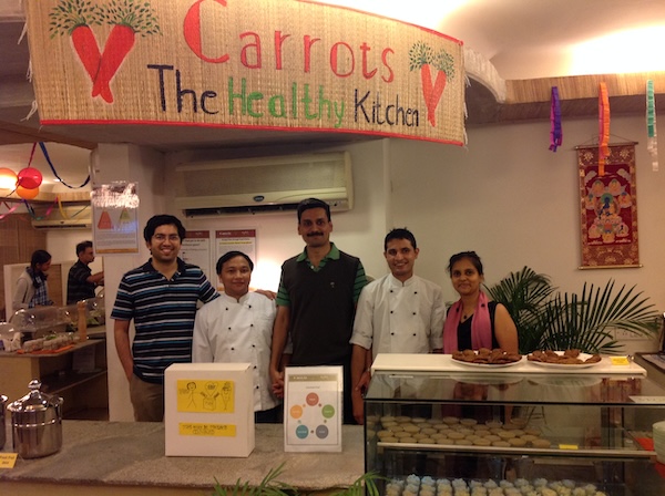 Carrots restaurants leaders and owners lined up at the counter. Small vegan business. Teamwork.