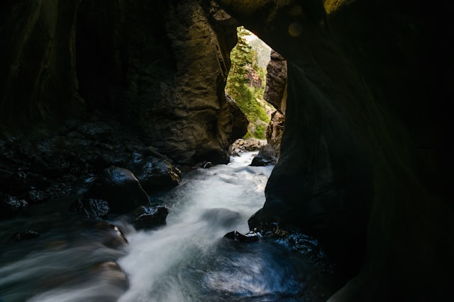 Gushing, flowing river through rock formations. Unstoppable force (water) immovable object (rocks).