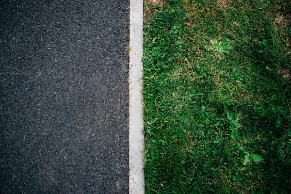 Grass and street. Clear, white, straight boundary line in between. Show boundaries, don't just talk about them.